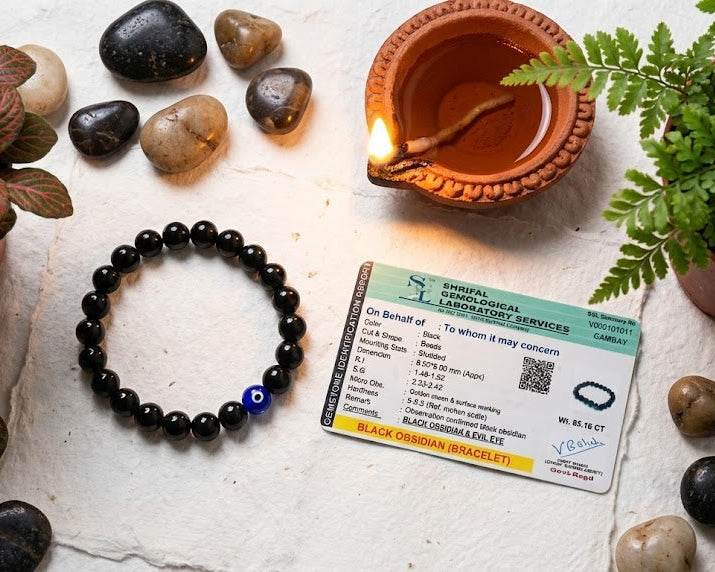 Black beaded bracelet, ID card, and decorative items on a textured surface
