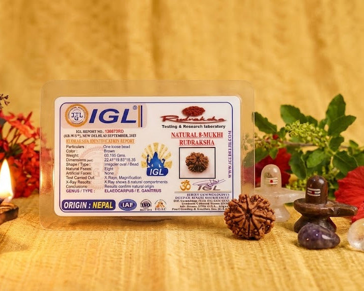 IGL certificate for a natural amulet on a wooden surface with decorative items.