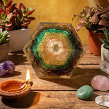 Decorative crystal on a wooden surface with plants and a lit candle