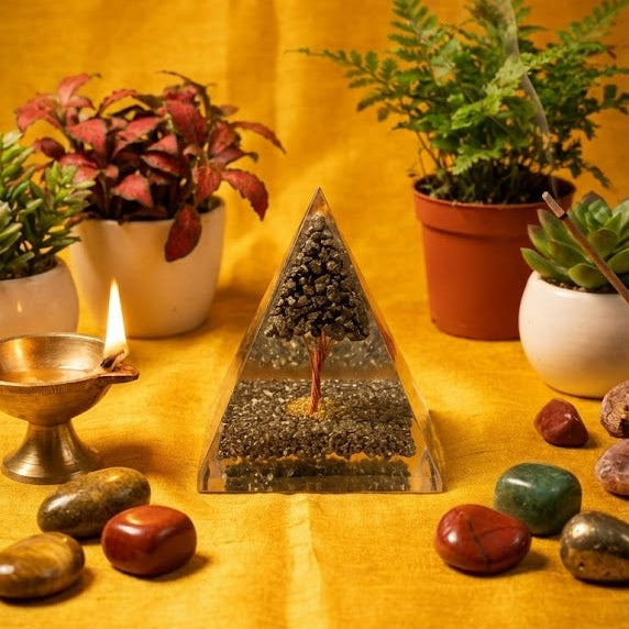 Triangular crystal pyramid with plants and stones on a yellow background