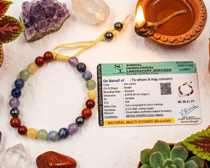 Chakra bracelet with a certificate on a table with crystals and plants