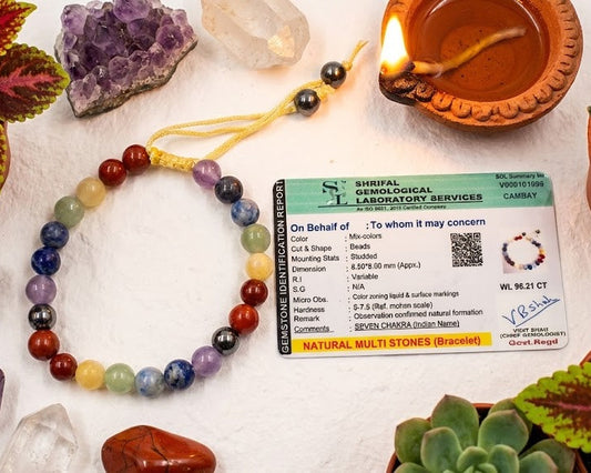 Chakra bracelet with a certificate on a table with crystals and plants