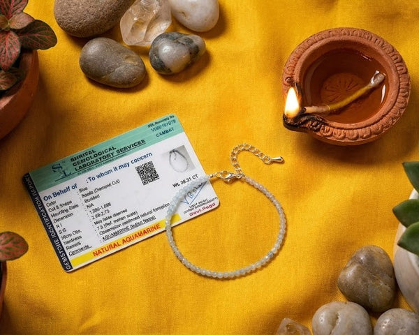 ID card, bracelet, and oil lamp on a yellow fabric background with plants.